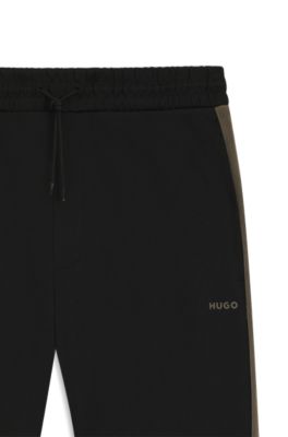 Pantalones de ch&aacute;ndal relaxed fit con cinta de logos, Negro