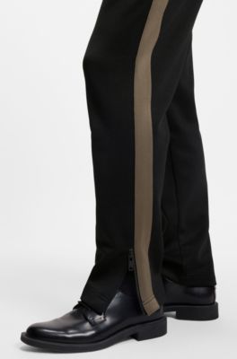 Pantalones de ch&aacute;ndal relaxed fit con cinta de logos, Negro