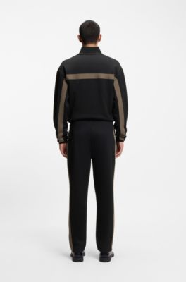 Pantalones de ch&aacute;ndal relaxed fit con cinta de logos, Negro