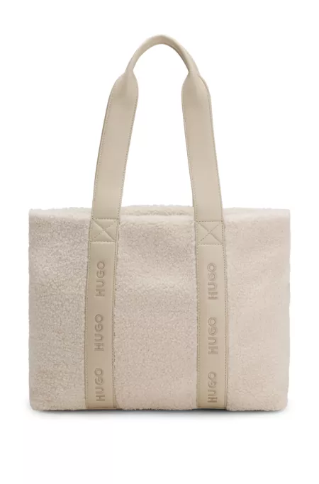 Logo-strap tote bag in faux shearling