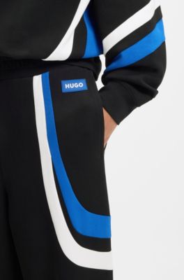 Stretch-cotton tracksuit bottoms with colourful panelling, Black