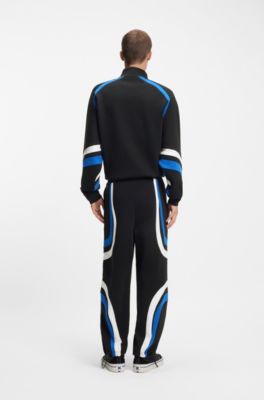Stretch-cotton tracksuit bottoms with colourful panelling, Black