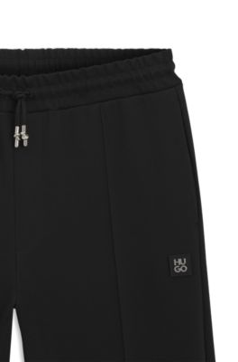 Pintuck-pleat tracksuit bottoms in a relaxed fit, Black