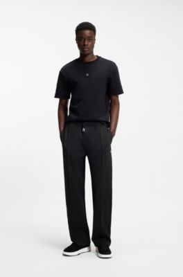 Pantalones de ch&aacute;ndal relaxed fit con pinzas, Negro