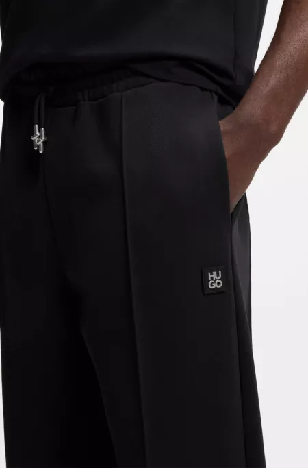 Pintuck-pleat tracksuit bottoms in a relaxed fit