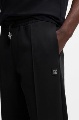 Pintuck-pleat tracksuit bottoms in a relaxed fit, Black