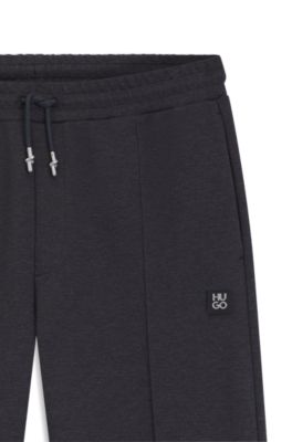 Pantalones de ch&aacute;ndal relaxed fit con pinzas, Gris