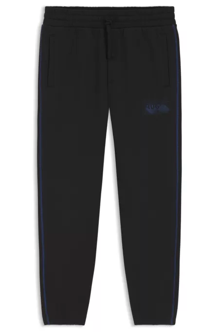 Logo-artwork tracksuit bottoms in cotton terry