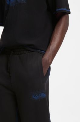 Pantalones de ch&aacute;ndal en felpa de algod&oacute;n con logo y pespuntes en contraste, Negro