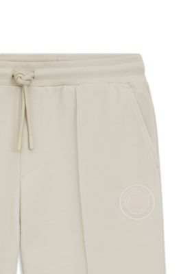 Cotton-blend tracksuit bottoms with tennis-themed logo, Light Beige