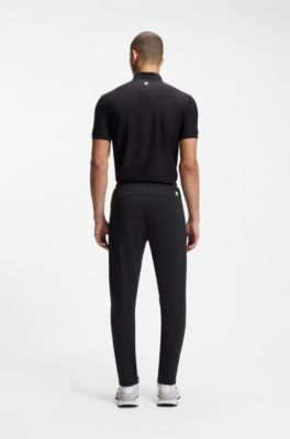 Active Pantalones de ch&aacute;ndal en tejido de gabardina el&aacute;stico con cremalleras en los bajos, Negro