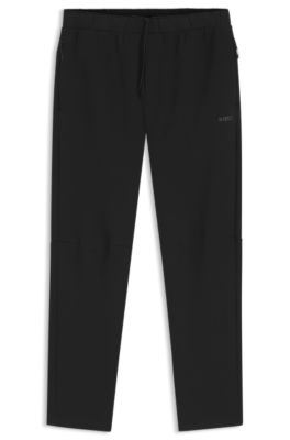 Pantalones de ch&aacute;ndal regular fit con detalles reflectantes, Negro
