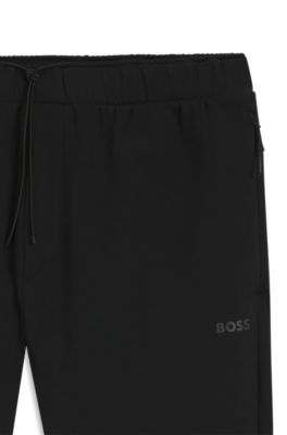 Pantalones de ch&aacute;ndal regular fit con detalles reflectantes, Negro