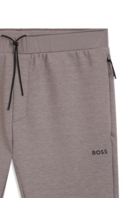 Pantalones de ch&aacute;ndal regular fit con detalles reflectantes, Gris claro