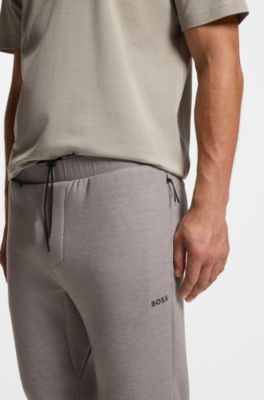 Pantalones de ch&aacute;ndal regular fit con detalles reflectantes, Gris claro