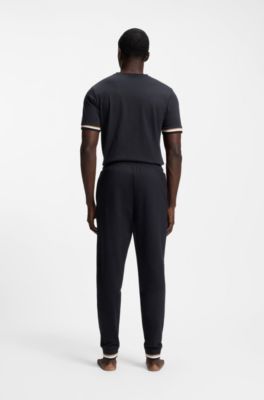 Pantalones de ch&aacute;ndal en felpa de algod&oacute;n con logo y rayas de la marca, Negro