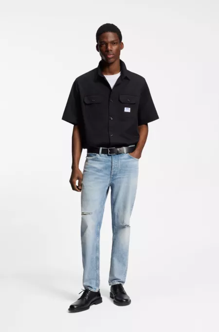 Blue tapered-fit jeans in distressed denim