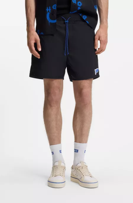 Water-repellent shorts with flag logo
