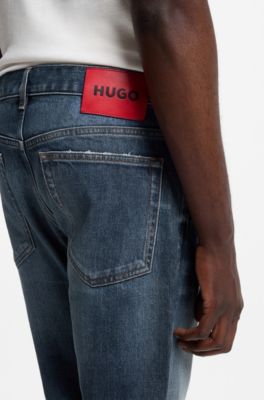 Jeans slim fit en denim el&aacute;stico azul oscuro desgastado, Azul