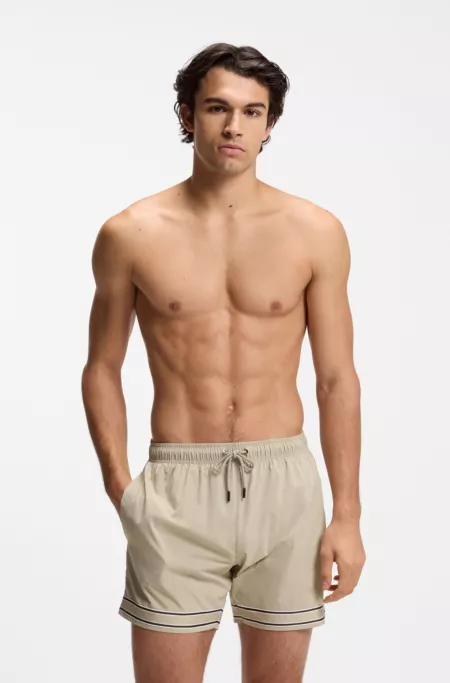 Drawstring swim shorts in stretch fabric with tape trim