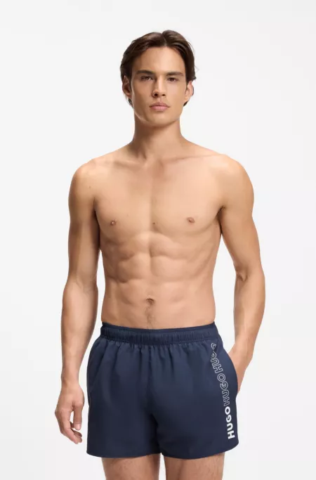 Swim shorts with repeated logos