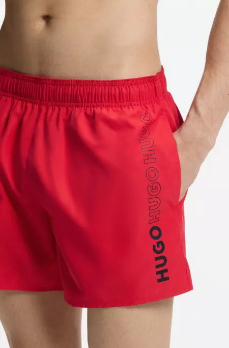 Swim shorts with repeated logos