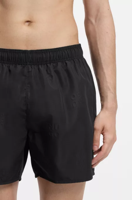 Swim shorts with all-over stacked logos