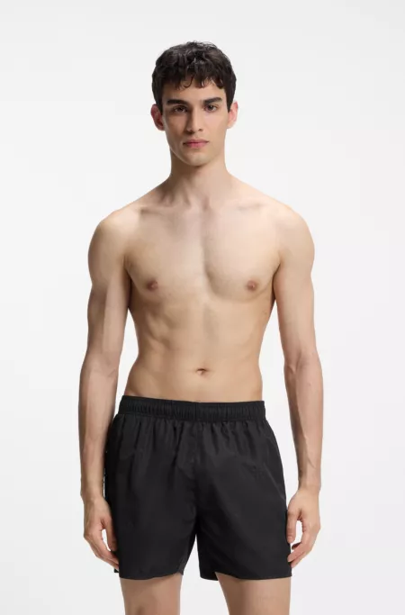Swim shorts with all-over stacked logos