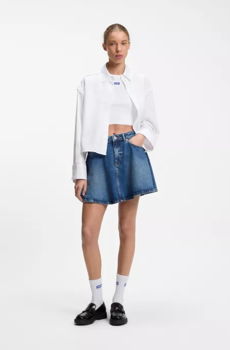 Oversized pinstriped cotton shirt with open-cut hem