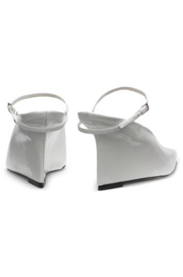 Glossy leather mules with wedge heel and strap, White