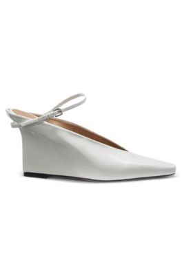 Glossy leather mules with wedge heel and strap, White