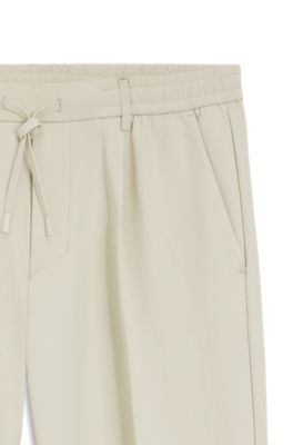 Pantalones tapered fit activos de tejido el&aacute;stico repelente al agua, Beige claro