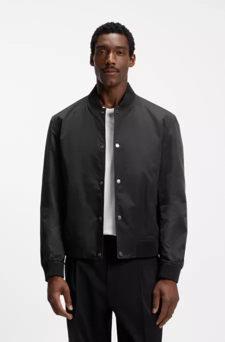 Water-repellent jacket with monogram-patterned sleeves