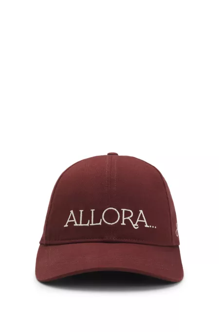 Woven cap with adjustable strap