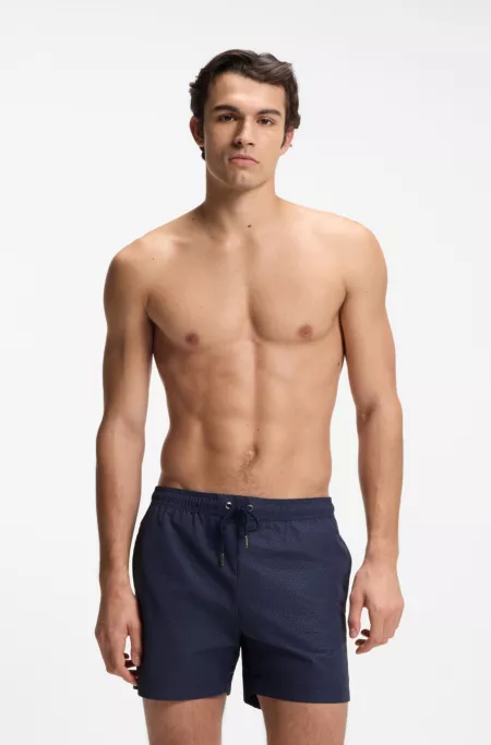 Swim shorts with all-over monogram print