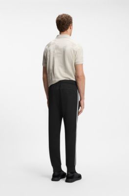 Triangle-jacquard track pants with rubberized logo, Black