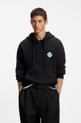 Sudadera con capucha relaxed fit de algod&oacute;n con estampado gr&aacute;fico, Negro