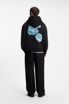 Sudadera con capucha relaxed fit de algod&oacute;n con estampado gr&aacute;fico, Negro