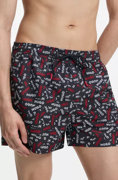 Drawstring swim shorts with all-over logo print
