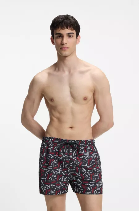 Drawstring swim shorts with all-over logo print
