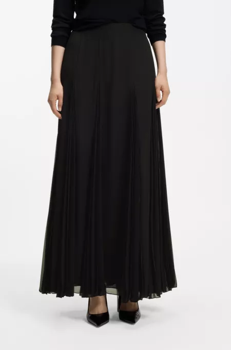 Long skirt with fluid plissé inserts