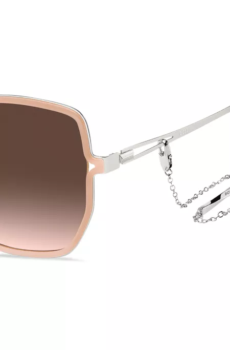Nude-frame sunglasses with forked temples and branded chain