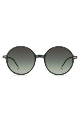 Round-frame sunglasses in green acetate with branded chain