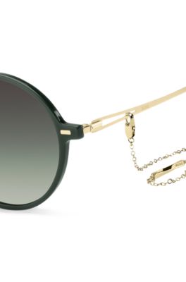 Round-frame sunglasses in green acetate with branded chain