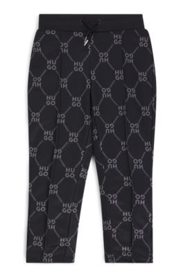 Kids' loose-fit tracksuit bottoms with stacked-logo print, Black