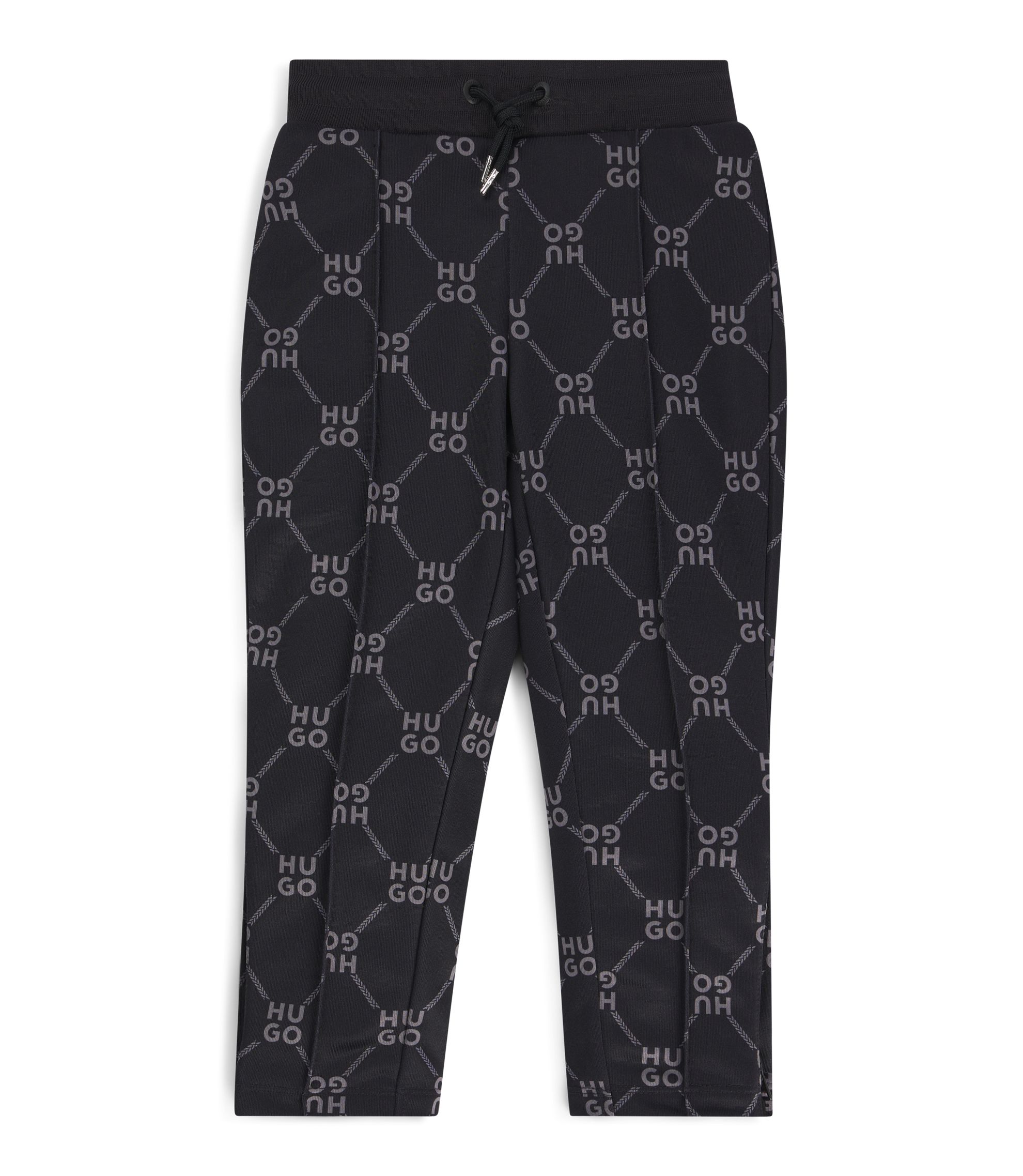 Kids' loose-fit tracksuit bottoms with stacked-logo print