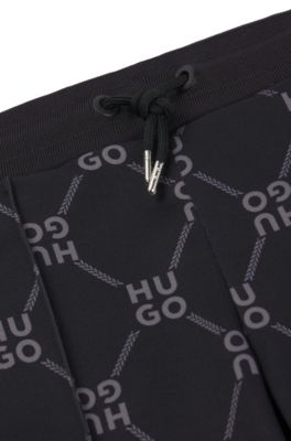 Pantalones de ch&aacute;ndal loose fit para ni&ntilde;os con logo apilado estampado, Negro