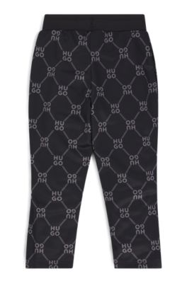 Kids' loose-fit tracksuit bottoms with stacked-logo print, Black