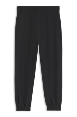 Kids' track pants with piping and logo, Black