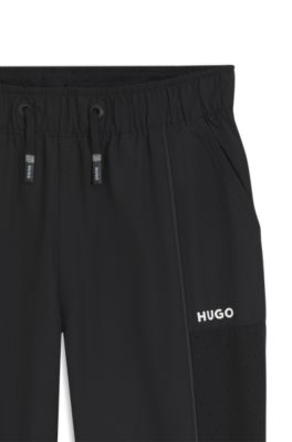 Kids' track pants with piping and logo, Black